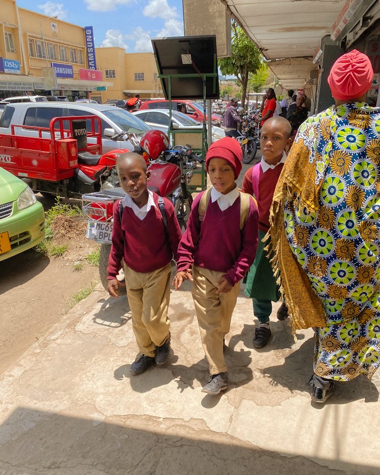 Boys Wearing School Uniform Walking On A Sidewalk