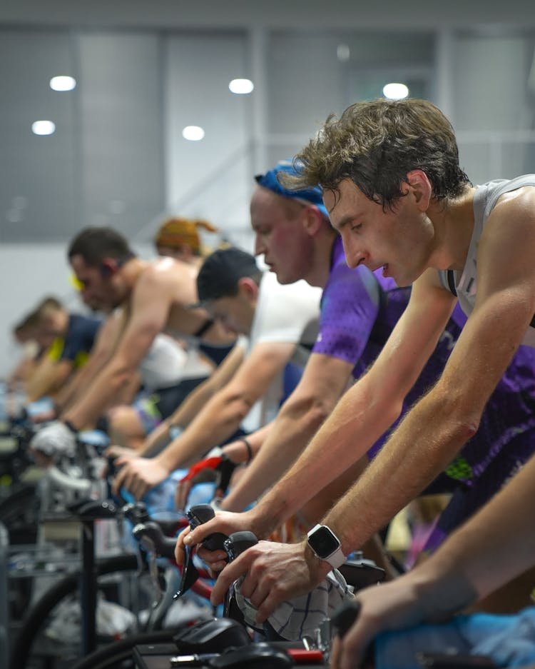 Men Exercising Using An Indoor Bike