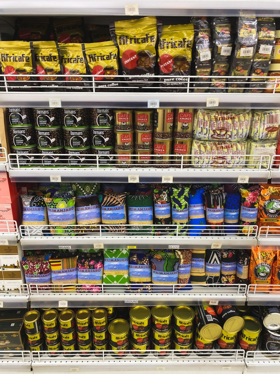 Coffee products lined up on supermarket shelves, one of the fastest ways weather-driven crop stress shows up in a household budget.