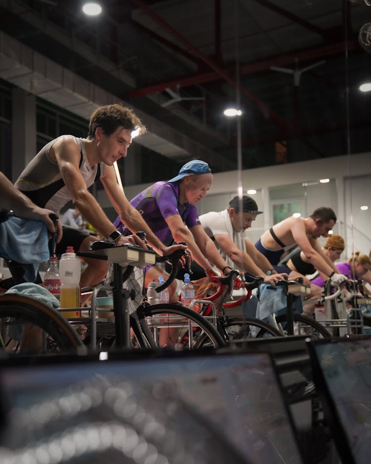 People On Bikes Cycling Together In Gym