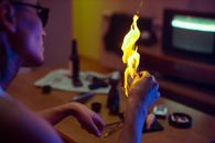 Person Holding Yellow Fire on Table