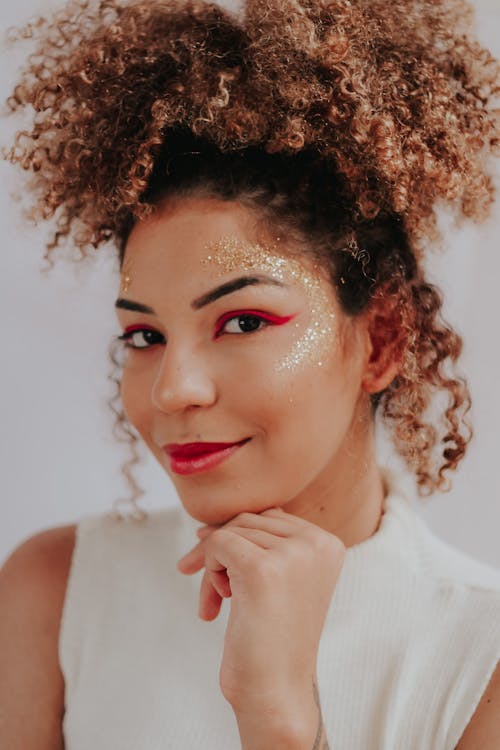 Close-Up Shot of an Afro-Haired Woman Looking at Camera