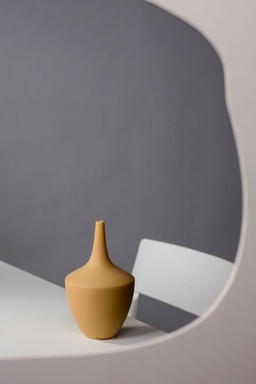 Free A simple, elegant ceramic vase reflected in a stylish mirror, perfect for minimalist decor. Stock Photo