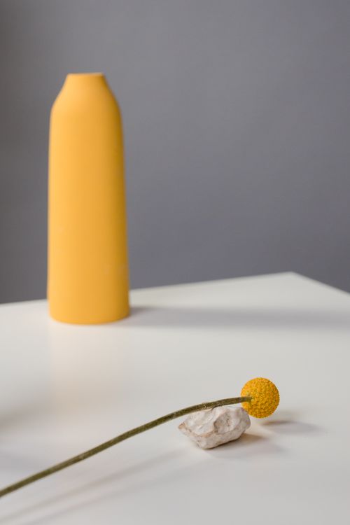 Free Elegant minimalist composition with yellow vase and Craspedia flower on a white table. Stock Photo