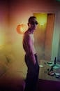 Topless Man in Sunglasses Standing in Room
