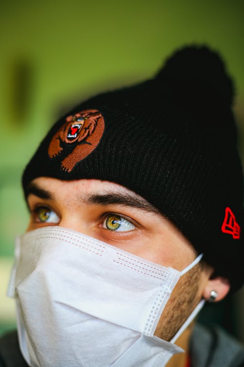 Close-Up Shot of a Man with Face Mask and Black Bonnet