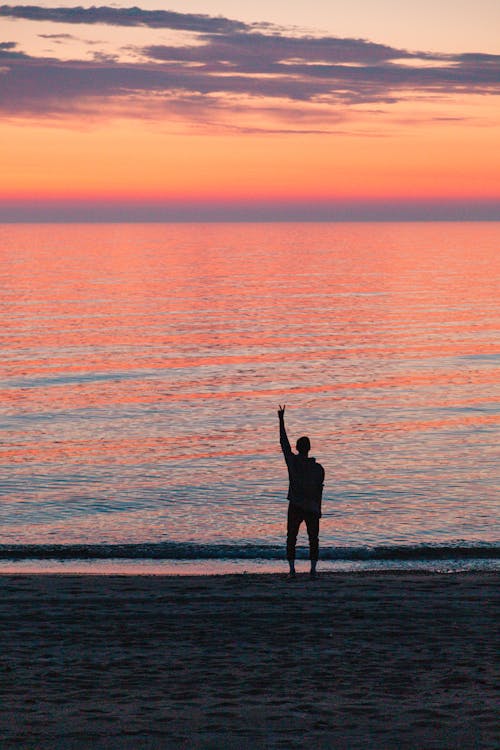 Free Man Standing at the Beach Stock Photo