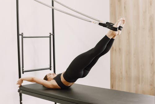 Woman in Black Leggings and Sports Bra Working Out