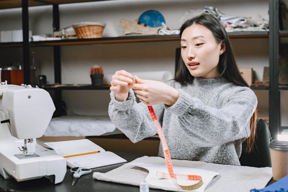 Founder Marlowe Vane at her worktable with measuring tape and sewing materials