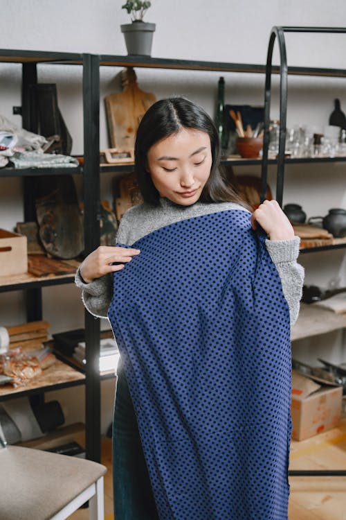 A Woman Holding a Blue Fabric