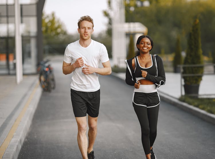 Man And Woman Jogging At A Walkway