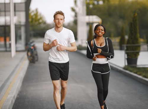 Free A man and woman jogging together outside, embracing a healthy lifestyle. Stock Photo