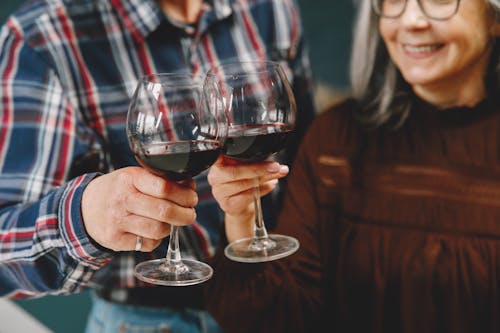 People Holding Glass Wine with Red Wine