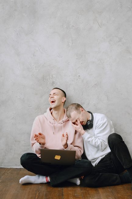 A joyful LGBTQ couple laughing together, capturing love and happiness. A joyful LGBTQ couple laughing together, capturing love and happiness.