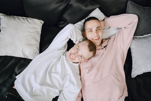 Free Two Young Men Lying in Bed Daydreaming Stock Photo