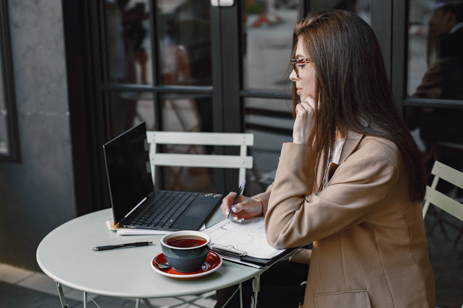 person researching on a laptop with a notepad - how to find a good alcohol rehab center person researching on a laptop with a notepad - how to find a good alcohol rehab center