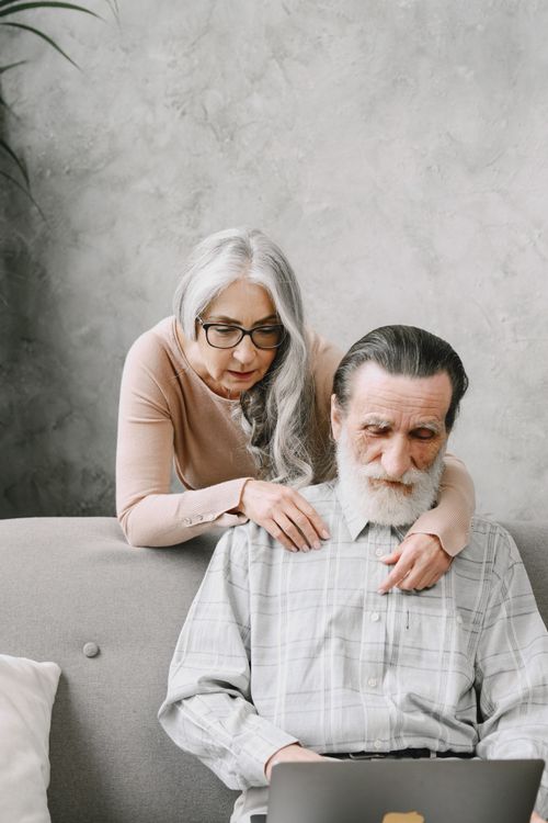 Free Elderly couple exploring technology on a cozy couch at home. Stock Photo