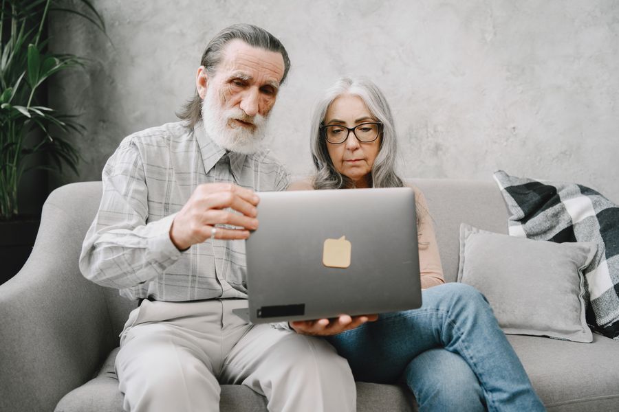 Senior couple reviewing information on a laptop