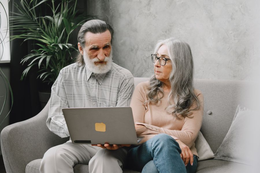 Older couple sitting together on a sofa