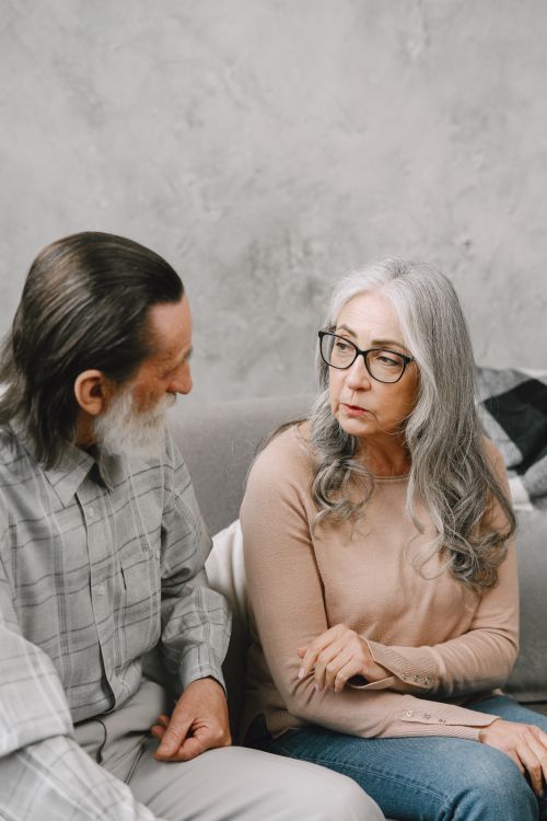 Free Senior couple sharing a thoughtful conversation indoors. Stock Photo
