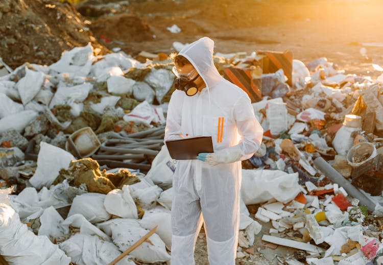 Person In PPE On A Dumpsite