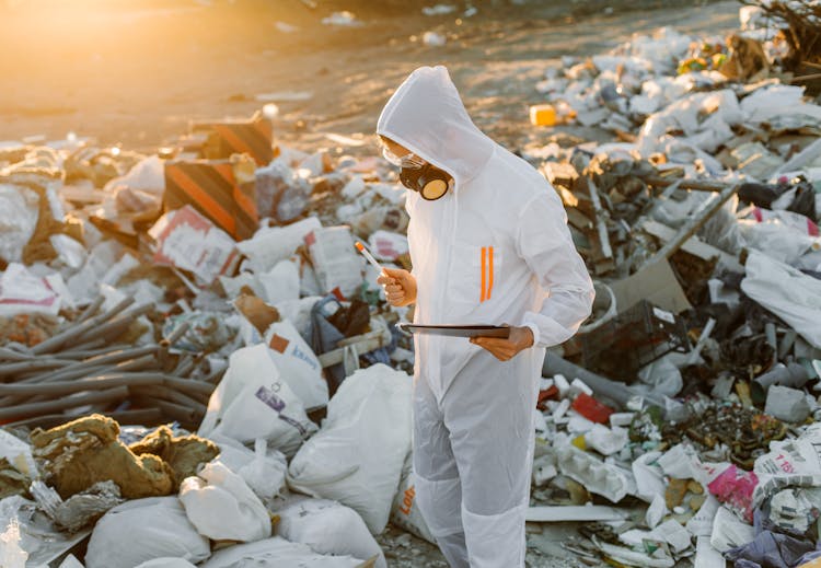 Person In PPE On A Dumpsite