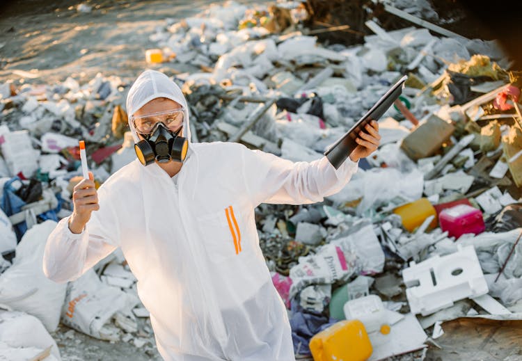 Person In PPE On A Dumpsite