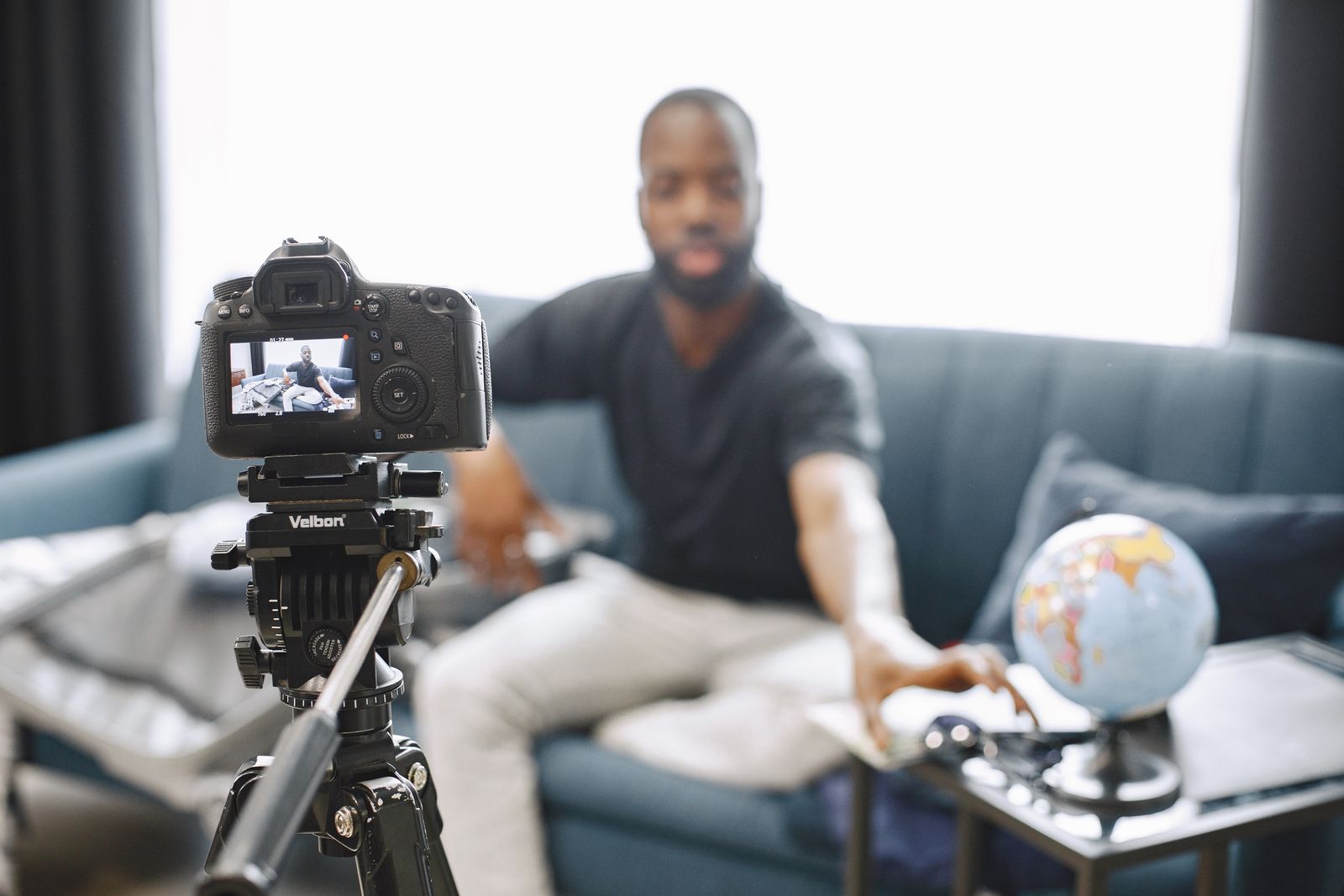 A creator recording a video using a camera on a tripod