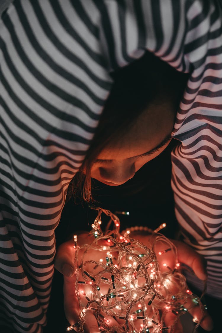 Woman Holding White String Lights