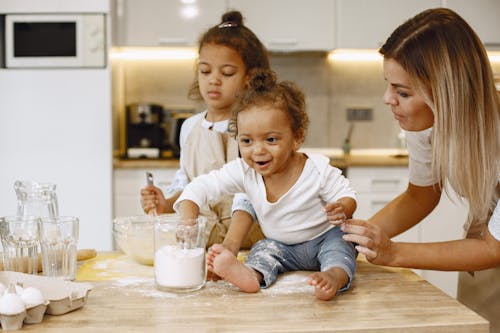 Free Mother holding her Child seated on a Counter Top  Stock Photo