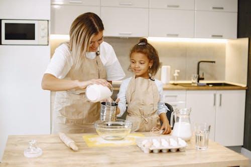 A Woman and a Young Girl Baking in the Kitchen