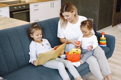 Girl Reading a Book Beside Her Mother