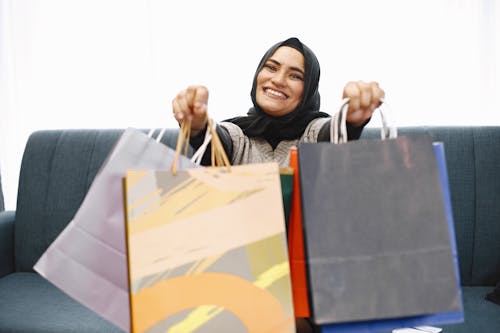 Woman in Black Hijab Holding Shopping Bags