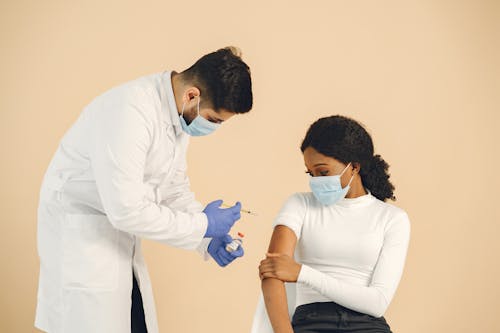 Man Vaccinating a Woman