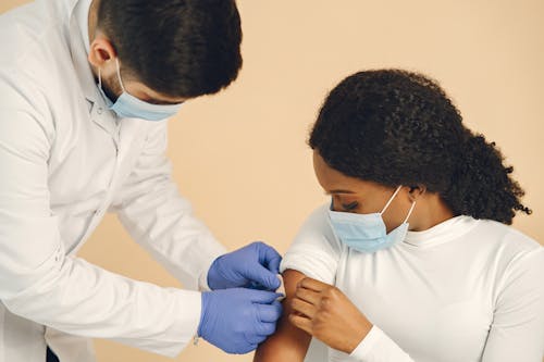 Man Putting a Band Aid on a Woman