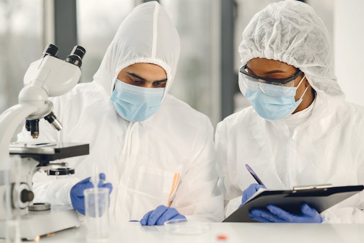 People In White Overalls Working In A Laboratory 