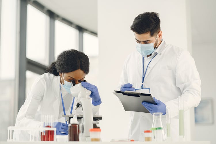 Man And Woman Wearing White Lab Coat Doing Laboratory Analysis