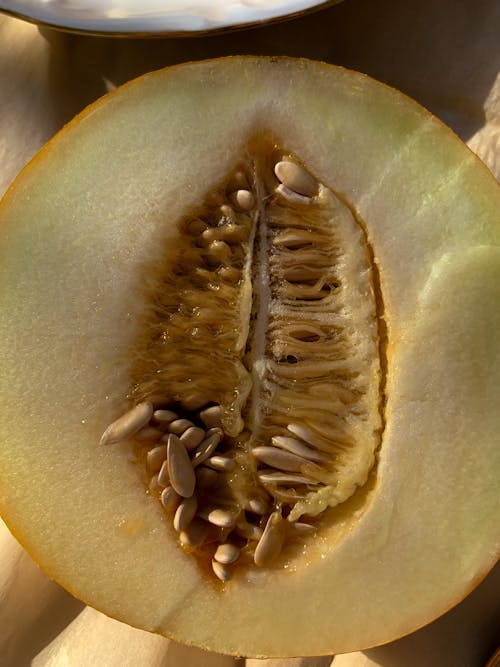 Free Sliced Green Fruit on Yellow Textile Stock Photo