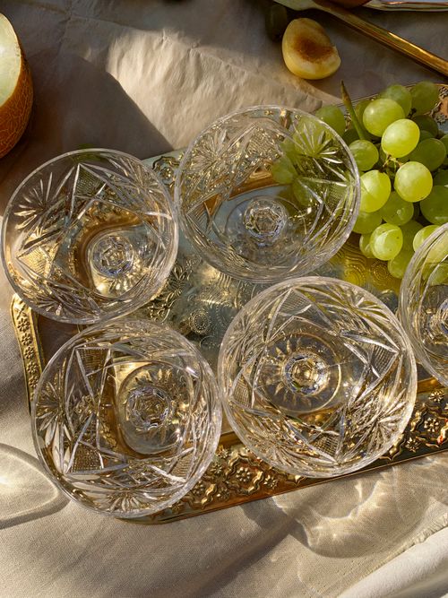Free Crystal bowls with grapes on a gold serving tray, featuring a still life composition. Stock Photo