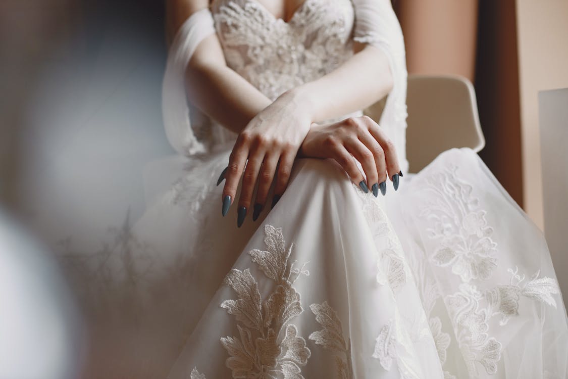 Free Bride Sitting in Her Lace Wedding Dress Stock Photo