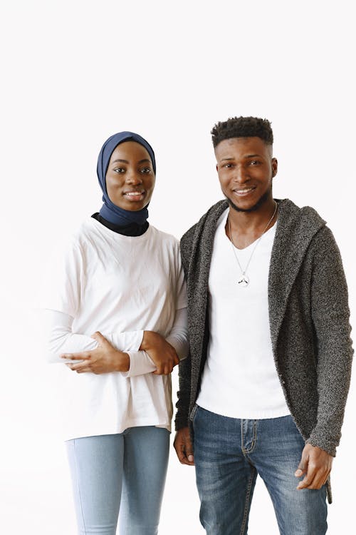 Woman Wearing Blue Hijab and Man in Black Jacket