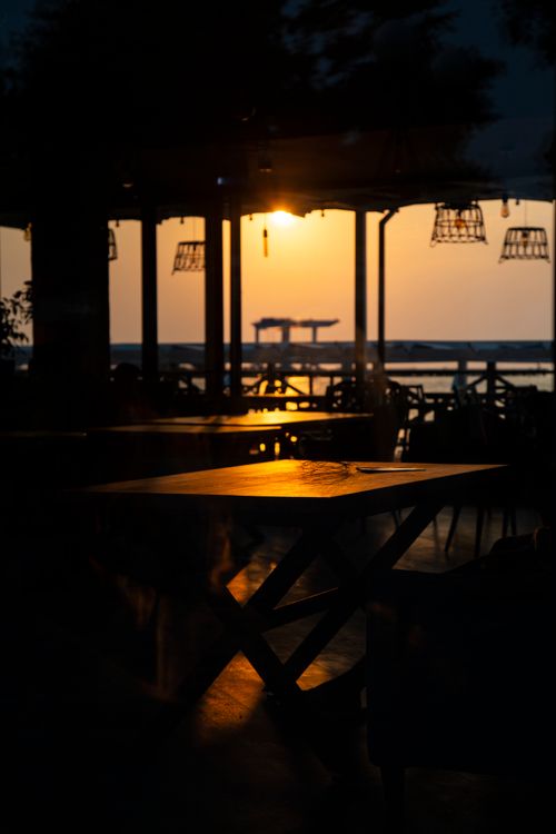 Free Warm sunrise view from a seaside restaurant in Anapa, Russia, capturing a serene moment. Stock Photo