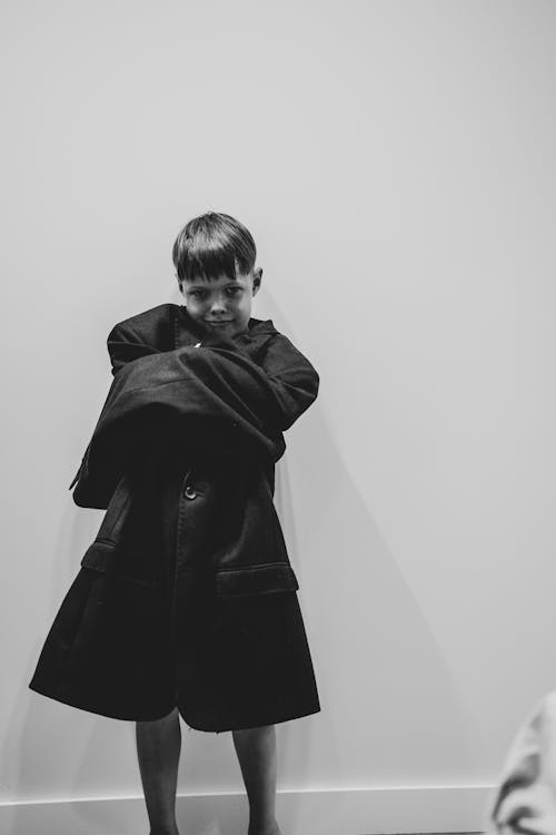 Grayscale Photo A Boy Wearing Coat