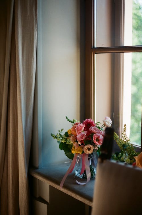 A Flower Vase beside a Window