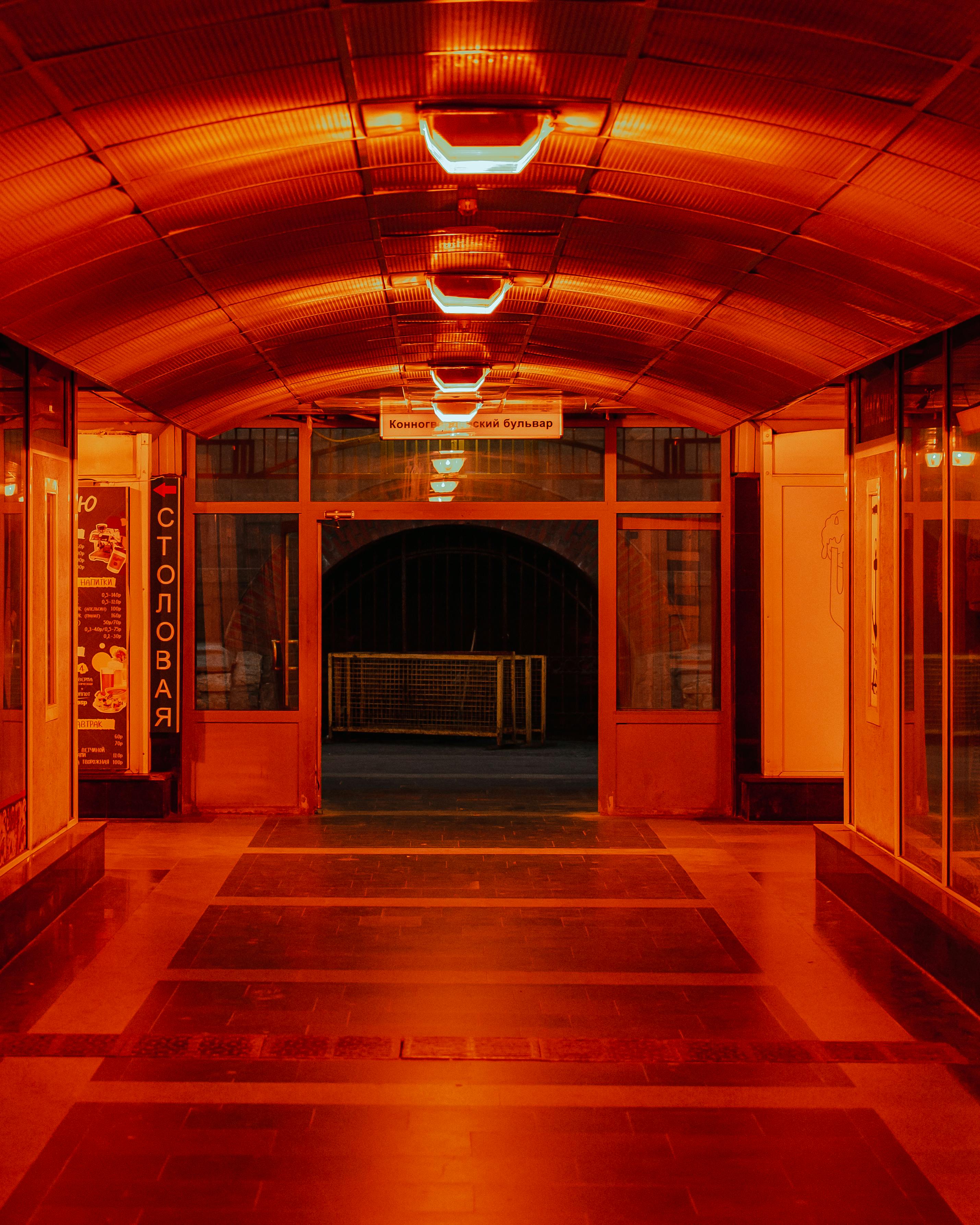 Dimly lit hallway with orange lighting in Saint Petersburg, showcasing unique architectural design.