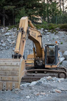 Excavator working in a rocky field in Norway, showcasing heavy machinery operation.