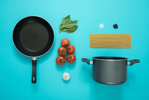 Free Black and Gray Cooking Pot and Frying Pan With Tomatoes Stock Photo