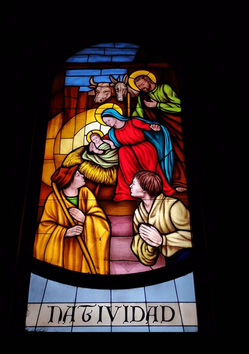 Free Colorful stained glass depicting Nativity scene, found in a Catholic church. Stock Photo