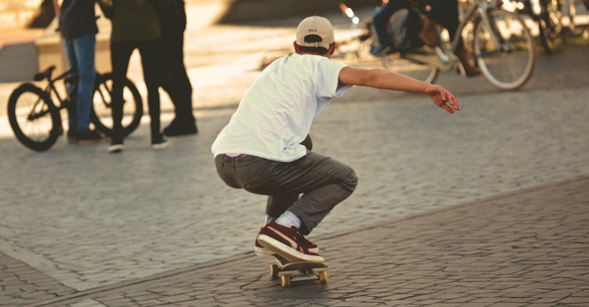 Man in White Shirt and Brown Jeans Riding Skateboard