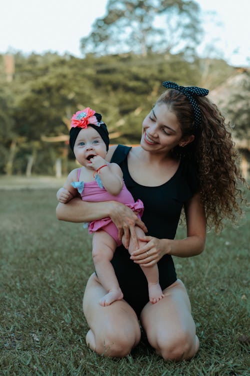 Smiling Mother Holding Her Cute Baby